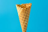 Image of an empty ice cream cone on a blue background.