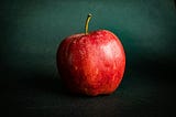 a red apple on a green background