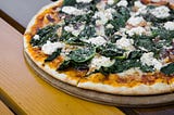 Pizza topped with spinach