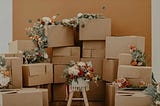 Piles of cardboard boxes with strings of flowers