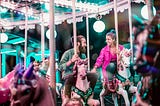 A couple looking at each other on a caroussel