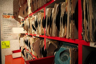 A photograph of a rack of hundreds of vinyl records