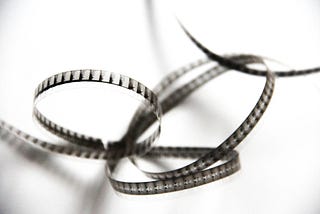 Interlocking spirals of black and white movie film.