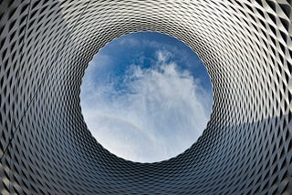 Picture of a view of the sky through a cylindrical, tessellated object