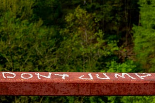 A bridge with the words “Don’t Jump” on the railing.
