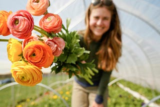 A woman hands you a bouquet of colorful flowers