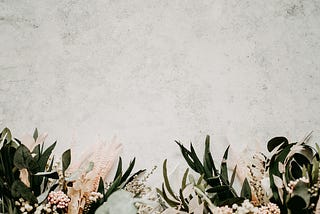 A row of pastel flowers at the bottom of a picture of granite
