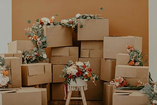 Piles of cardboard boxes with strings of flowers