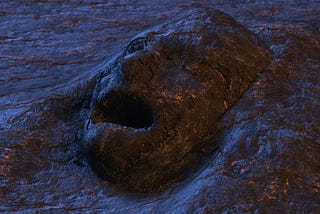 An indistinct but masculine-looking face, its mouth agape, emerges from an enveloping stone-like substance.