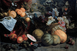 A painting of a still life with dark fabric of red and green draped and hanging in front of a column with several round edges at the base. There are leaves and dried pods placed throughout the fruits and vegetables, several clusters of dark purple, light green, light red grapes and vines filled and overflowing a light brown woven basket. There are melons, gourds, fruit, and white flowers in front of the basket and to the side, with one gourd cut in half.