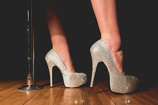 pair of feet wearing high heel platform sparkly shoes
