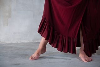 A woman dances barefoot.