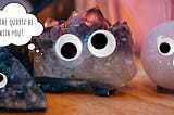 A picture of quartz geodes, with googly eyes and a thought bubble that says “may the quartz be with you!”