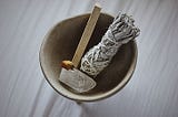 Sage smudge stick in a bowl