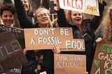 demonstrators with sign that reads Don’t be a Fossil Fool