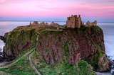 Image of Dunnottar Castle at sunset showing both high and low roads.