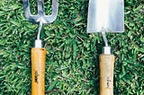 Grass with a garden trowel and fork