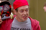 Steve Buscemi dressed as a skater boy, complete with “Music Band” T-shirt.