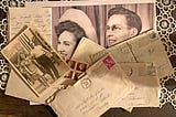 Closeup of a few old faded photos of a happy young couple and scattered envelopes and letters on a white doily on an old wood table.