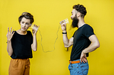 A man and woman communicating effectively through cups with yellow background