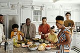 a family of different generations are cooking together in the kitchen
