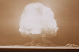 The Trinity atomic bomb test in July 1945, showing a mushroom cloud explosion. Screen grab from a National WWII Museum video.