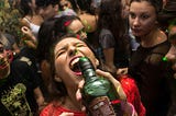 Young woman drinking alcohol at party
