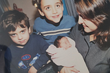 Image by author; 12/11/2001; Seattle, WA. Pictured from left: Brandon (age 3), Brashaw (age 5), Baby Brooke, and author holding baby.