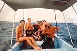 A group of divers, including Gentry Bronson, on a dive boat off the coast of the island of Utila, Honduras