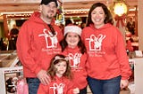 The writer and his family dressed in matching toy drive sweatshirts.