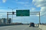 A road sign showing Montreal in French Canada as we drive on a bridge.