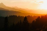 Sunset over layers of mountains and forest