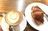 A Latte and a ham and cheese croissant