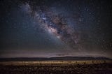 Night sky with milky way visible. On open desert.