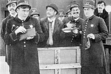 black and white photo of several keystone cops surrounding a witness in court