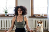 A woman and her dog meditation together. Meditation can change the brain structure and chemistry.