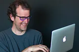 A developer using a MacBook computer. Generated by AI.