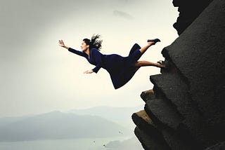 Woman falling off a cliff