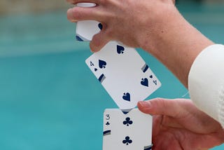 The writing trick no one ever told you. Hands performing card trick by the pool
