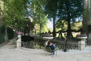 solitary person sat by a fountain