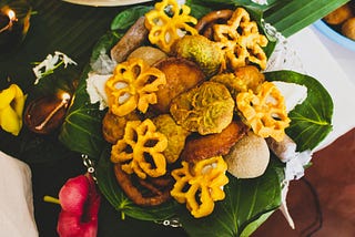 A plate of traditional New Year food from Sri Lanka, presented on betel leaves.