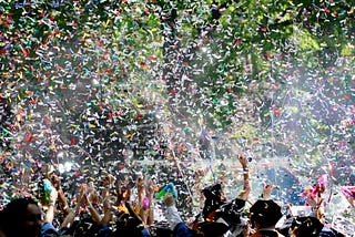 Confetti permeates the air at a college’s commencement ceremony.