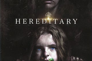 Hereditary movie poster with a woman in shadow stands behind a nervous child