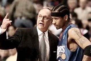 Coach Larry Brown talking to Allen Iverson on the sidelines.