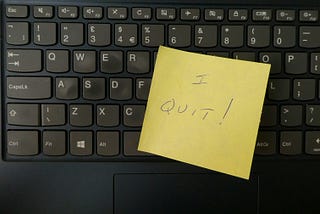 Post-It note reading, “I QUIT!” on keyboard