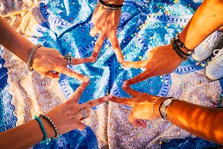 Friends with stack of hands showing unity and teamwork — mandale outdoor background