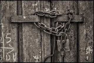 Chain and padlock on steel doors.