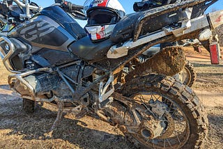Closeup of mud- and sand-splattered motorcycle. If you think there’s a lot of dirt on this motorcycle, you should have seen the rider!