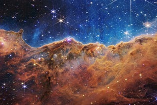 Orange clouds full of stars against a backdrop of stars