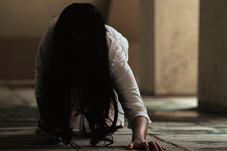 woman with long hair crawling on hands and knees
